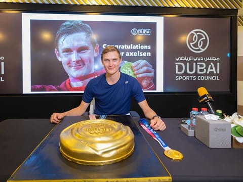 Viktor Axelsen celebrates at Dubai Sports Council with a giant gold medal cake