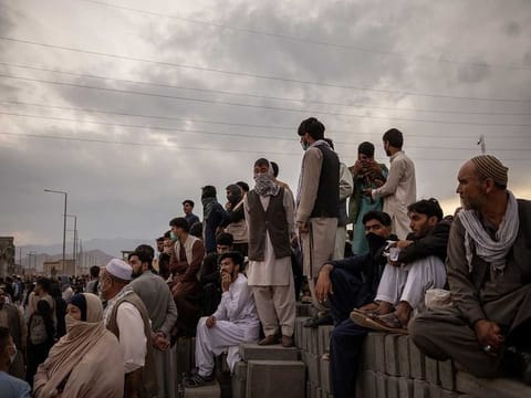 Hoping to flee the country, people gather outside the airport in Kabul, Afghanistan on Friday, Aug. 20, 2021. 