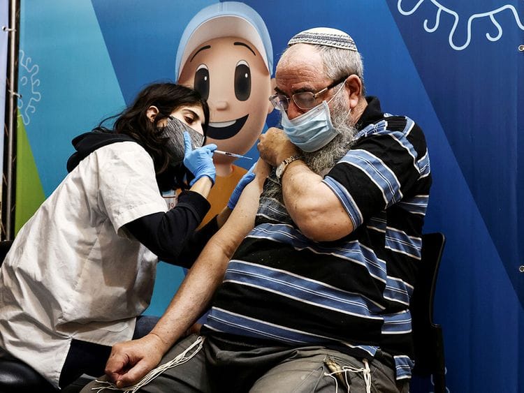 A man receives his third dose of the COVID-19 vaccine in Jerusalem. 