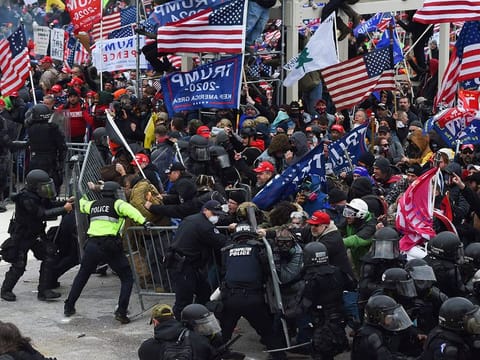 In this file photo taken on January 06, 2021 Trump supporters clash with police and security forces as they push barricades to storm the US Capitol in Washington DC. 