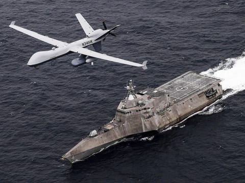 An MQ-9 Sea Guardian unmanned maritime surveillance drone flies over the USS Coronado in the Pacific Ocean during a drill April 21, 2021.  