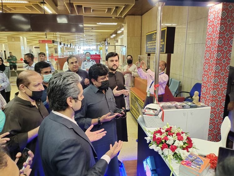Sindh Education and Culture Minister Syed Sardar Ali Shah and Special Assistant to CM on Investment Syed Qasim Naveed pray after inaugurating tourist facilitation desk at Karachi International Airport.  