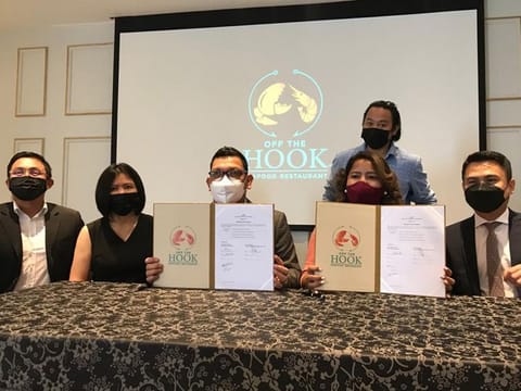Investors during the Off the Hook franchise signing ceremony on Friday