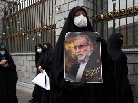 A protester holds an image of the Iranian nuclear scientist Mohsen Fakhrizadeh during a demonstration outside Parliament in Tehran on Saturday, November 28, 2020, a day after Fakhrizadeh was killed. Israeli agents had wanted to kill Iran’s top nuclear scientist for years. Then they came up with a way to do it with no operatives present. 