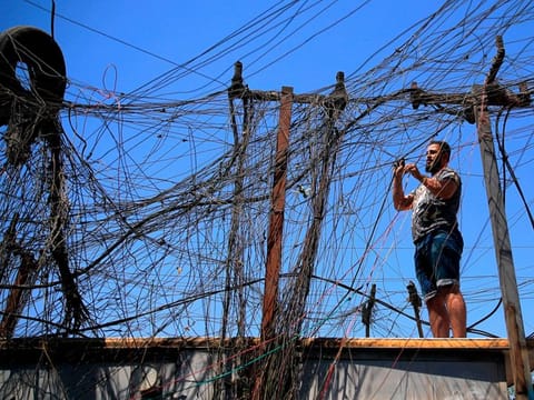 Muqtada Haider turns the switches to transfer electricity to private homes in Baghdad on September 10, 2021. In Iraq, electricity is a potent symbol of endemic corruption, rooted in the country’s sectarian power-sharing system. 