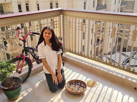 Umme Kulsum Saif in her Dubai apartment's balcony where she cares for birds 