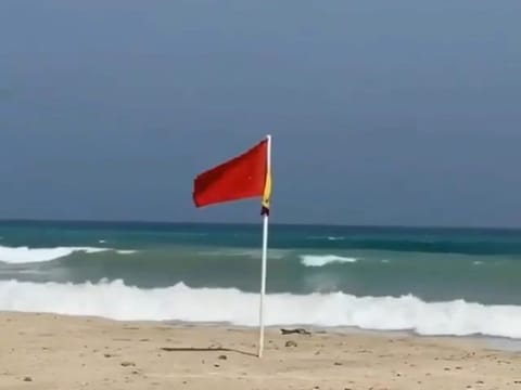 The red flag has been raised on Kalba beach to warn beachgoers about approaching Cyclone Shaheen. 