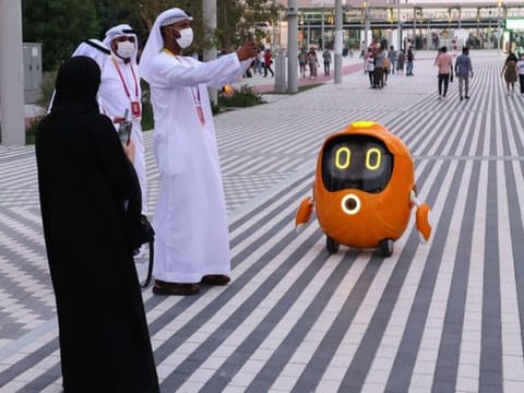 Visitors take pictures of a robot outside the Dutch pavilion at the Expo 2020 Dubai