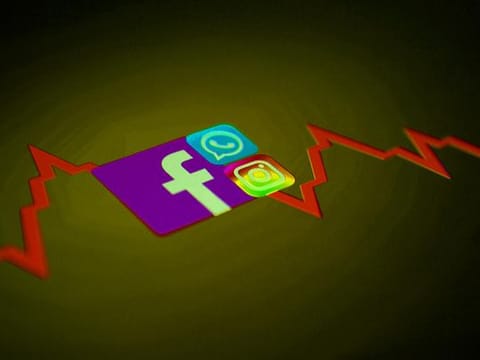 Facebook, Whatsapp and Instagram logos and stock graph are seen displayed in this illustration taken October 4, 2021.