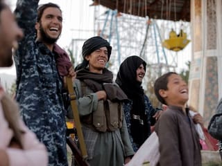 Photos: Battle-hardened Taliban fighters enjoy a day off at amusement park 