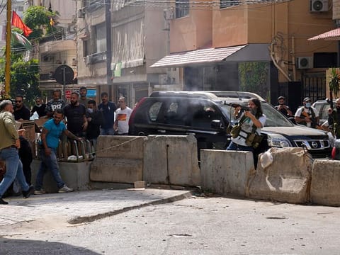  Supporters of a Shiite group allied with Hezbollah fire during armed clashes that erupted during a protest in the southern Beirut suburb of Dahiyehon October 14, 2021.