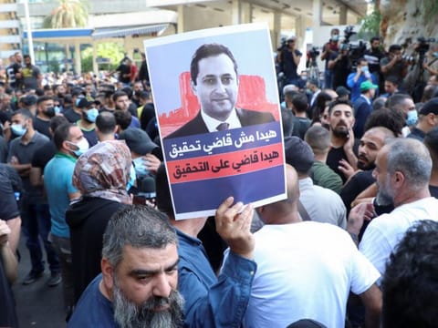 Supporters of Hezbollah and Amal and the Christian Marada movement take part in a protest against Tarek Bitar, the lead judge of the port blast investigation, near the Justice Palace in Beirut, on October 14, 2021. 