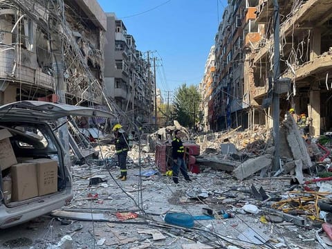 In this photo released by Xinhua News Agency, policemen and firefighters walk through damaged shophouses following a gas explosion in Shenyang in northeastern China's Liaoning Province, Thursday, Oct. 21, 2021.  