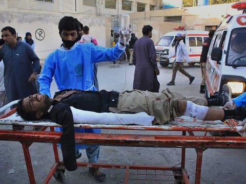 Paramedics transport a police officer who was injured in a deadly bomb blast, following his initial treatment at a hospital, in Quetta, Pakistan, Monday, Oct. 18, 2021.  