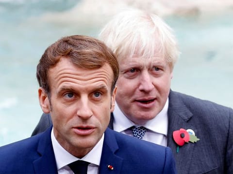 File picture: Britain's Prime Minister Boris Johnson (right) and French President Emmanuel Macron look on in front of the Trevi Fountain during the G20 summit in Rome, on October 31, 2021. 