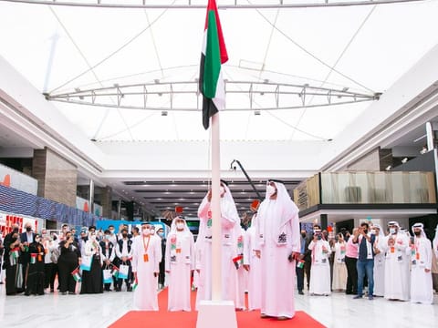 The UAE flag being raised at Sharjah International Book Fair in Expo Centre Sharjah on Tuesday. 