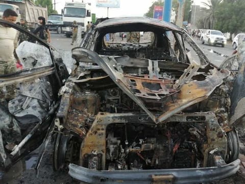 A security man inspects the wreckage of a car at the site of an explosion that killed a journalist in Aden, Yemen November 9, 2021.