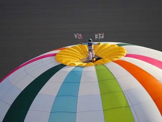 Photos: French daredevil breaks world record for standing on top of a hot air balloon
