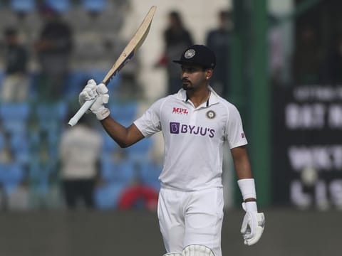 India's Shreyas Iyer raises his bat after scoring fifty runs during day four of the first Test cricket match against New Zealand in Kanpur, India.