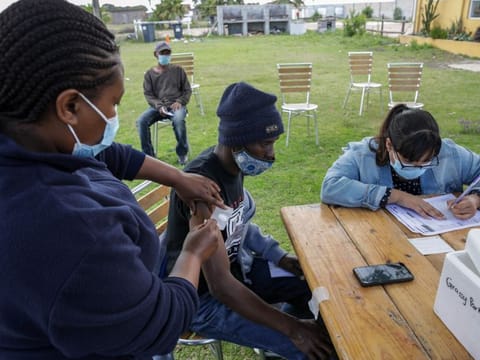 A health worker administers a dose of the Pfizer-BioNTech Covid-19 vaccine at CAFDA (Cape Flats Development Association) in the Egoli township of Cape Town, South Africa, on Tuesday, Nov. 30, 2021. South African scientists were last week the first to identify the new variant now known as omicron, and while symptoms have been described as mild, the exact risk from the new strain is still uncertain. Photographer: Dwayne Senior/Bloomberg