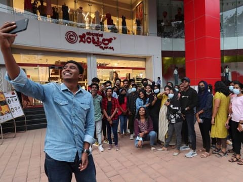 A group of young people outside a shopping mall in Bengaluru, capital of the southern Indian state of Karnataka.