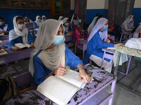 Students wearing facemasks attend a class at a school in Lahore in a file photo.