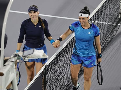 Tunisia's Ons Jabeur shakes hands with Switzerland's Belinda Bencic after their match in Abu Dhabi