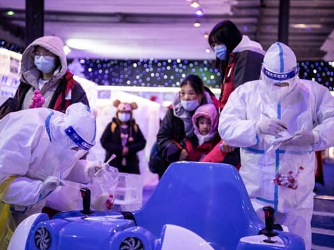 Health workers collecting samples to be tested for COVID-19 at an ice and snow themed park in Wuhan in China's central Hubei province on December 21, 2021.. 