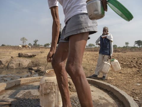 Men fill water containers from a hand pump well in Imlidol, India. India, one of the world’s most water-stressed countries, is halfway through an ambitious drive to provide clean tap water by 2024 to all the roughly 192 million households across its 600,000 villages. 