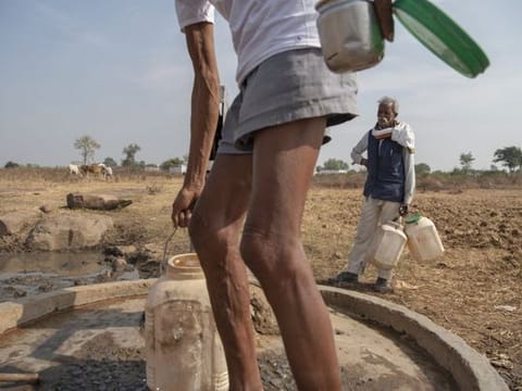 Men fill water containers from a hand pump well in Imlidol, India. India, one of the world’s most water-stressed countries, is halfway through an ambitious drive to provide clean tap water by 2024 to all the roughly 192 million households across its 600,000 villages. 