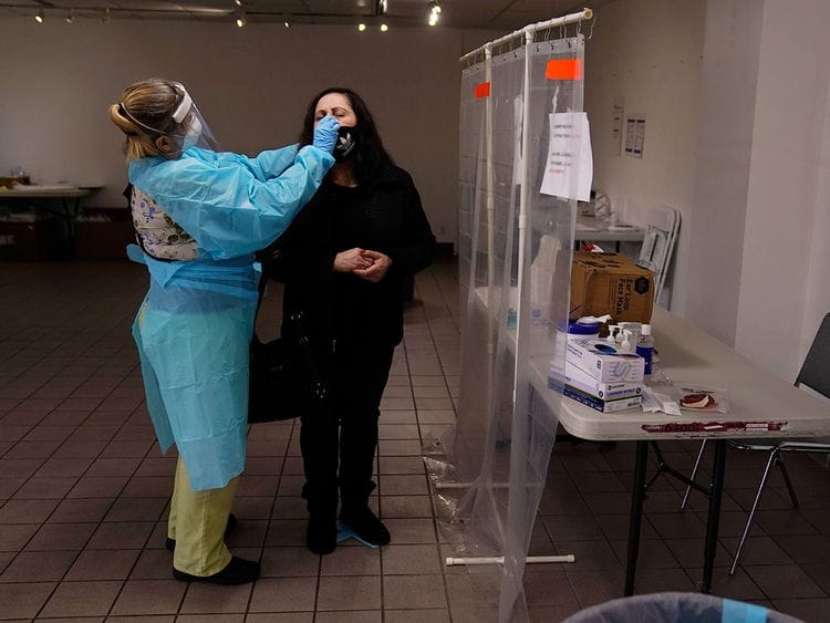 A nurse collects a nasal swab