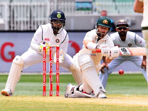 Australia's Matthew Wade (C) sweeps a ball as India's Rishabh Pant (L) and Ajinkya Rahane (R) look on on the third day of the second cricket Test at the MCG in Melbourne.  