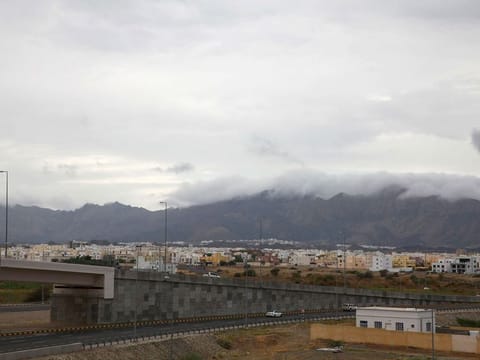 Clouds cover mountain tops in Oman's Al Amirat area, on January 1, 2022.