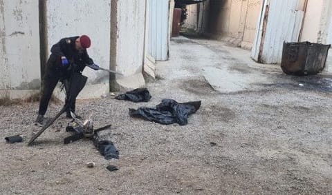 A member of the security checks the remains of two armed drones at the site where the US-led coalition shot them down near Baghdad Airport.  