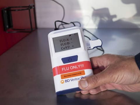 Steve Farzam, chief operating officer of 911 COVID Testing, shows a multiple antigen test for flu and COVID on January 5 2022 at the site near the Getty Center in Los Angeles where a teenage boy tested positive for 'Flurona'.  
