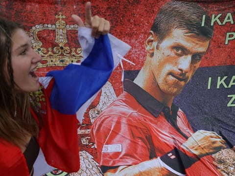 A supporter of Serbian world No.1 Novak Djokovic rallies outside the Park Hotel, where the star athlete is believed to be detained in Melbourne till his immigration appeal is heard again on Monday.
