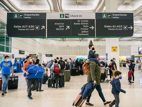 People travel through the George Bush Intercontinental Airport in Houston, Texas. 