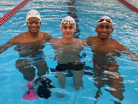 In good company: Vedaant Madhavan, flanked by Olympian Sajan Prakash (right) and Tanish George Mathew, at the Aqua Nation Swimming Academy in Dubai. 