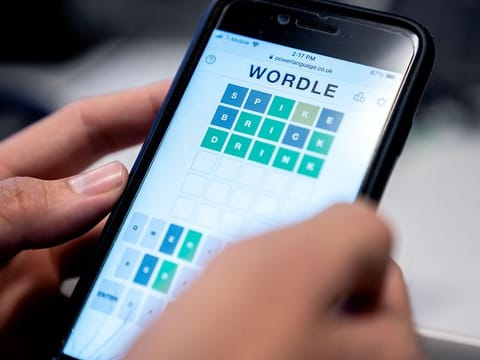 This photo illustration shows a person playing online word game “Wordle” on a mobile phone in Washington, DC on January 11, 2022.
