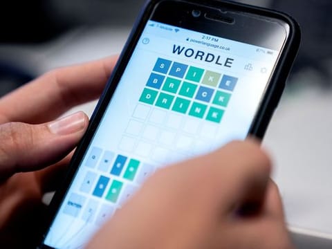 This photo illustration shows a person playing online word game “Wordle” on a mobile phone in Washington, DC on January 11, 2022.