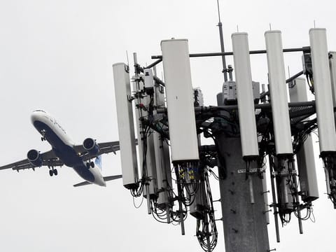 A cellular tower stands as an JetBlue Airbus A321neo airplane lands at Los Angeles International Airport (LAX) in the Lennox neighborhood of Los Angeles, California on January 19, 2022. The limits on 5G deployments and the FAA approvals meant little interruption at larger airports across the US.  