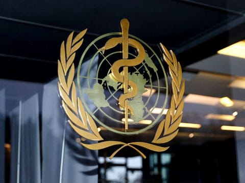 The World Health Organization logo is pictured at the entrance of the WHO building, in Geneva, Switzerland. 