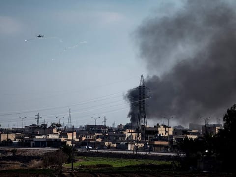 US attack helicopter shoots flares in Hasakeh, northeast Syria,  on January 26, 2022. With a spectacular jail break in Syria and a deadly attack on an army barracks in Iraq, Daesh was back in the headlines the past week, a reminder of a war that formally ended three years ago but continues to be waged away from view. 