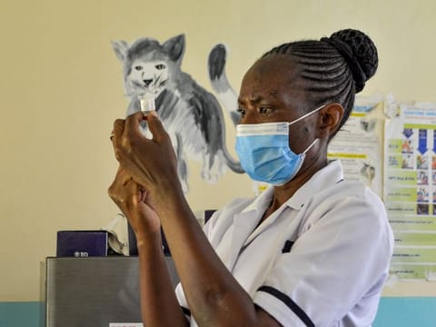 A health worker prepares a malaria vaccination for a child at Yala Sub-County hospital, in Yala. World Health Organization (WHO) approved using the malaria vaccine, Mosquirix, on children between 5-month to 5-year old in sub-Saharan Africa and other parts with moderate to high malaria transmission after the malaria vaccine implementation programme (MVIP) in Ghana, Kenya, and Malawi since 2019. 