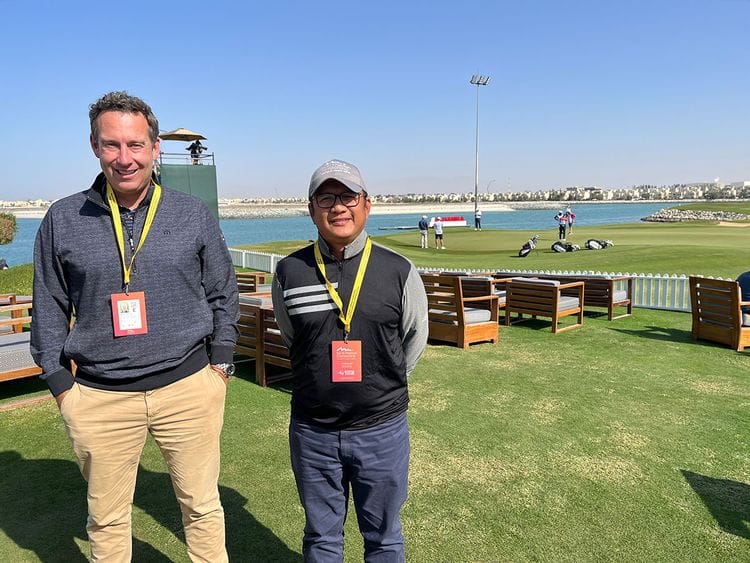 Superintendent Dindy Macaplang (right) alongside Troon's Clinton Southorn behind the 18th green at Al Hamra Golf Club.