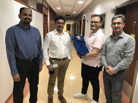 The newborn patient with his father and the Zulekha Hospital Dubai team.
