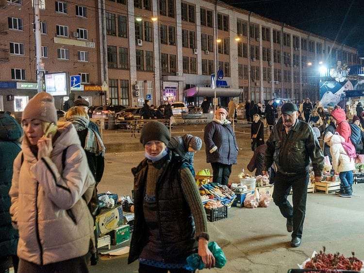 Street vendors sell vegetables and other local produce on the sidewalk outside Lukyanivska Metro station in Kyiv, Ukraine, on February 22, 2022. 