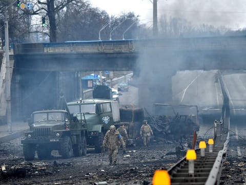 Ukrainian soldiers at the site of a fighting with Russian attack group in the Ukrainian capital of Kyiv on February 26, 2022. Ukrainian soldiers repulsed a Russian attack in the capital, the military said on February 26 after a defiant President Volodymyr Zelensky vowed his pro-Western country would not be bowed by Moscow.  