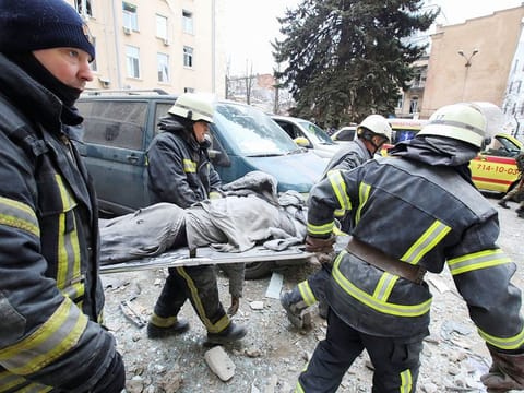 Rescuers carry the body of a victim on a stretcher outside the regional administration building, which city officials said was hit by a missile attack, in central Kharkiv, Ukraine, March 1, 2022. 