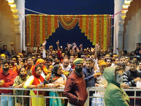 Devotees in large numbers arrive to offer prayers on the occasion of Maha Shivaratri, at Shri Kashi Vishwanath Temple, in Varanasi on Tuesday. 